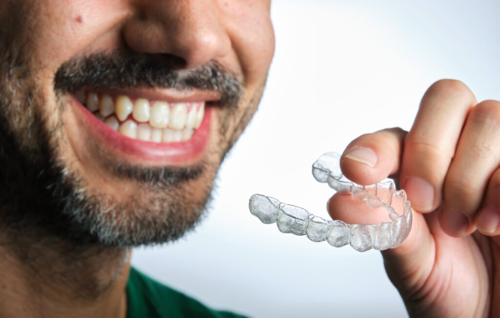 man with transparent dental retainer